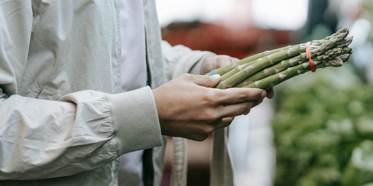 A person selecting items in a supermarket, reflecting diverse consumer choices in the plant-based market.