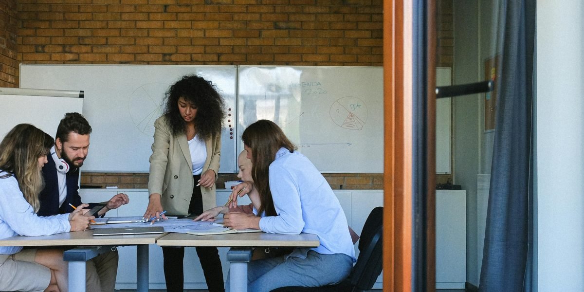 A team collaborating in a meeting, symbolizing the strategic challenges and competitive pressures in the market.