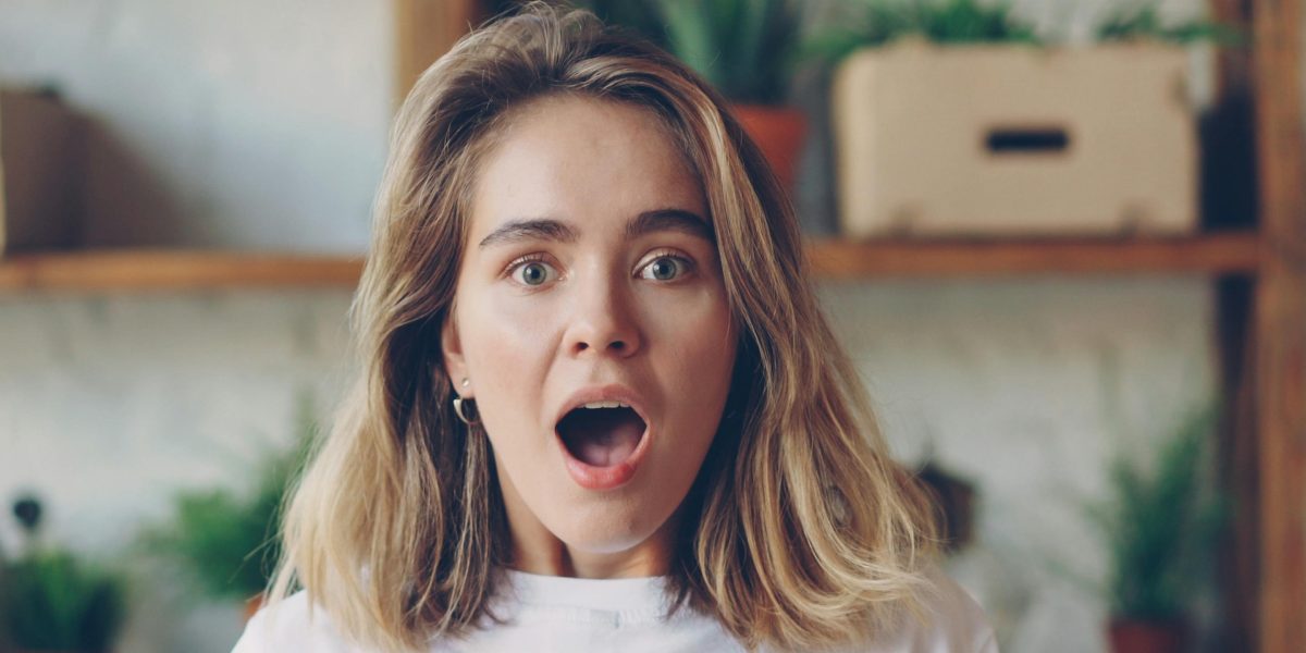 A person shows surprise or strong emotion while observing financial news, reflecting the sudden market movements discussed.