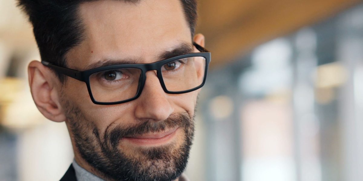 A confident professional reviewing reports, representing a strategic focus on stable, mega-cap leaders for portfolio foundation.