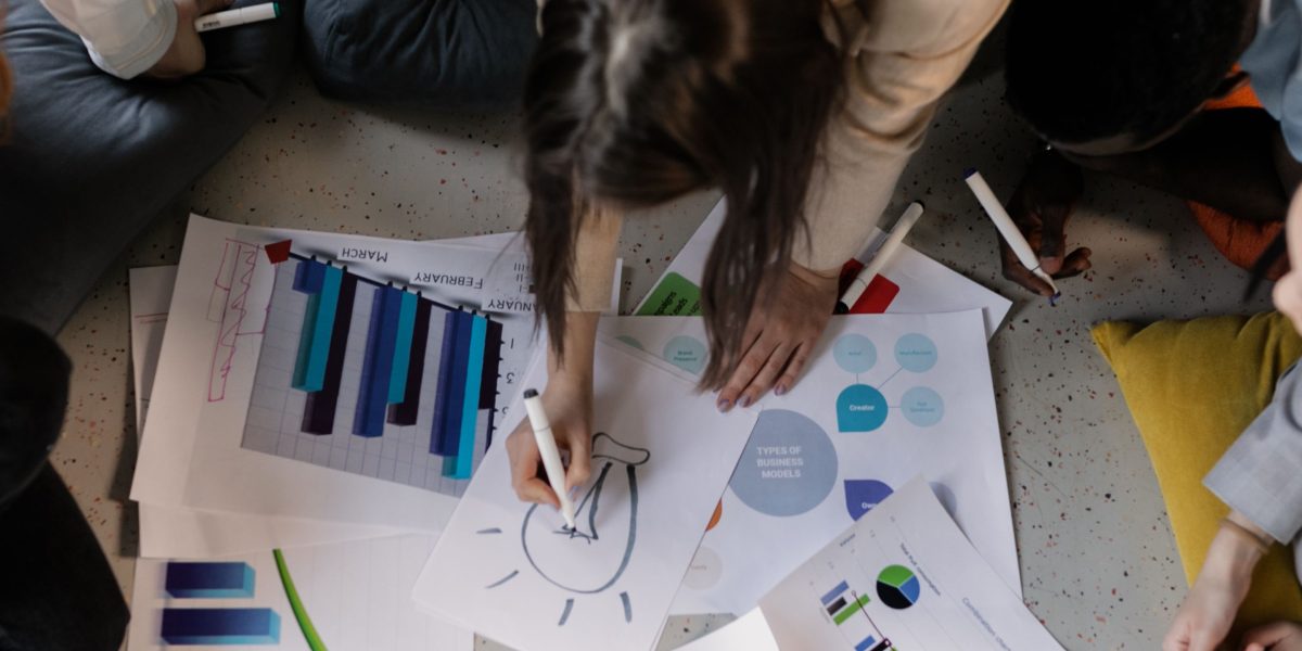 A group of diverse individuals actively collaborating, symbolizing a company's effort to build multiple, resilient revenue streams.