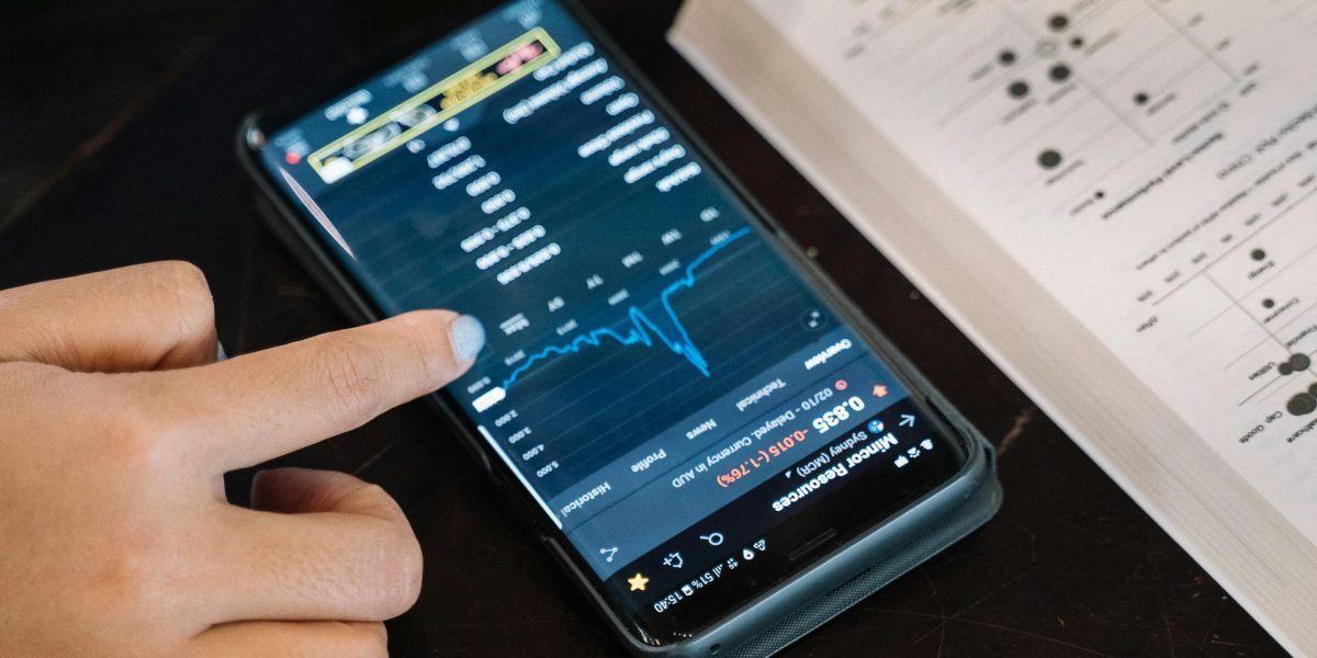 A person intently studying financial documents and charts, representing diligent research into insider and institutional stock movements.