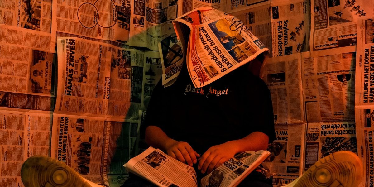 A person experiencing information overload from a constant stream of news headlines.