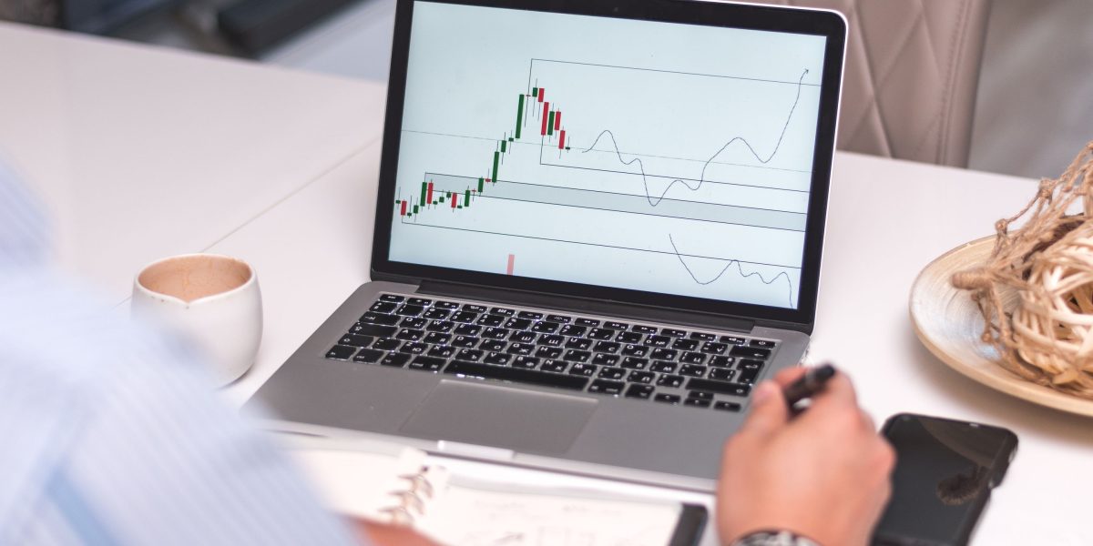 An individual deeply focused on financial data, reflecting the complexity of market analysis.
