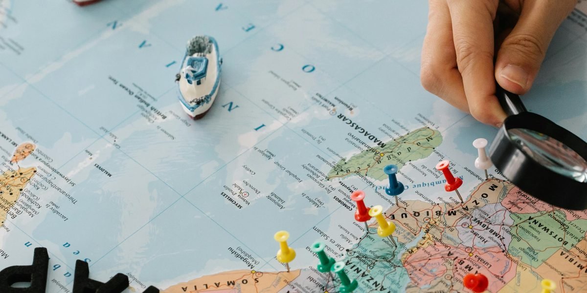 An individual contemplating a global map, representing the broad impact of geopolitical and regulatory risks on markets.