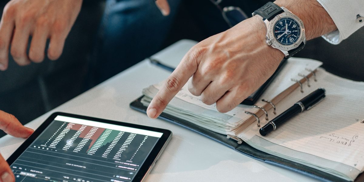 An investor thoughtfully reviews financial data, symbolizing the process of making informed stock decisions.