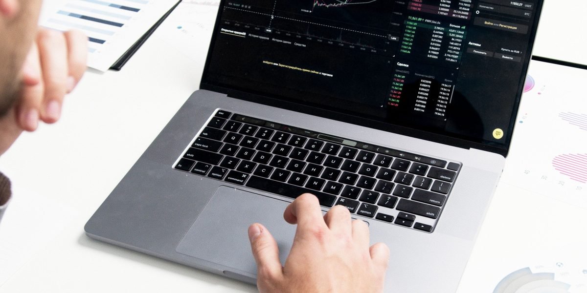 An investor diligently analyzing market trends and performance data to identify emerging patterns and make informed decisions.
