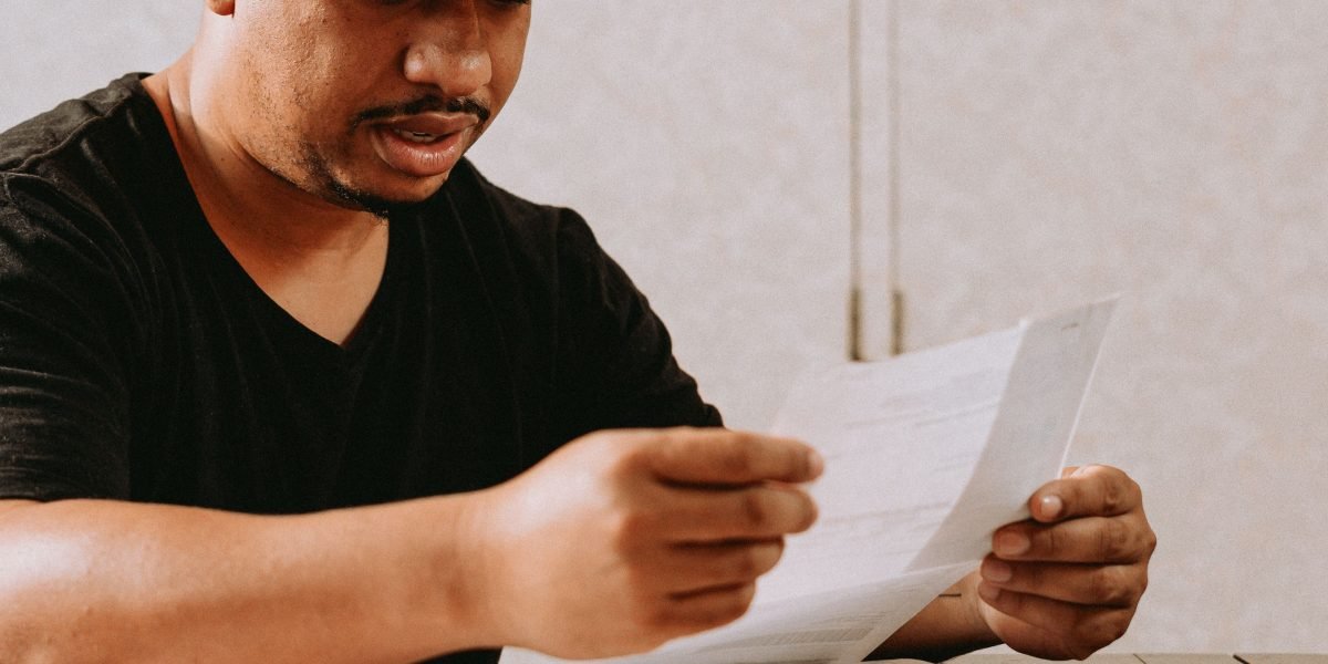 An investor reviews financial documents, contemplating the complexities of diversifying into a new, unfamiliar sector.