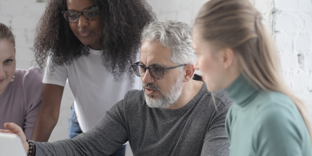 A diverse team working together, representing the broad diversification offered by a total market index fund.