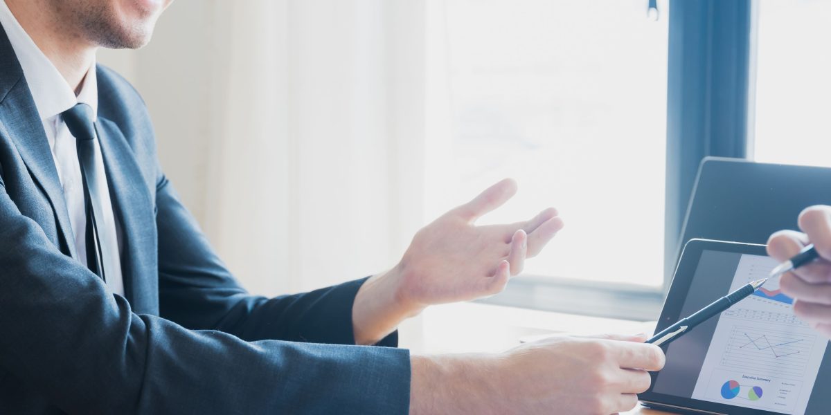 A financial professional discussing investment strategies with a client, reflecting expert advice on total market indexing.