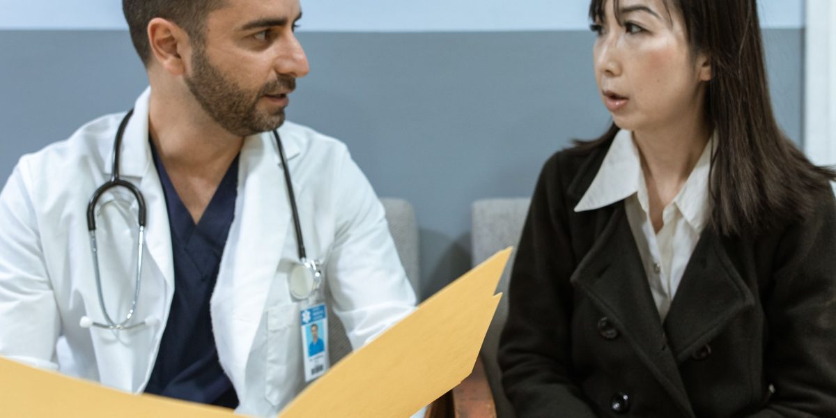 A doctor consults with an older patient about new health treatments.