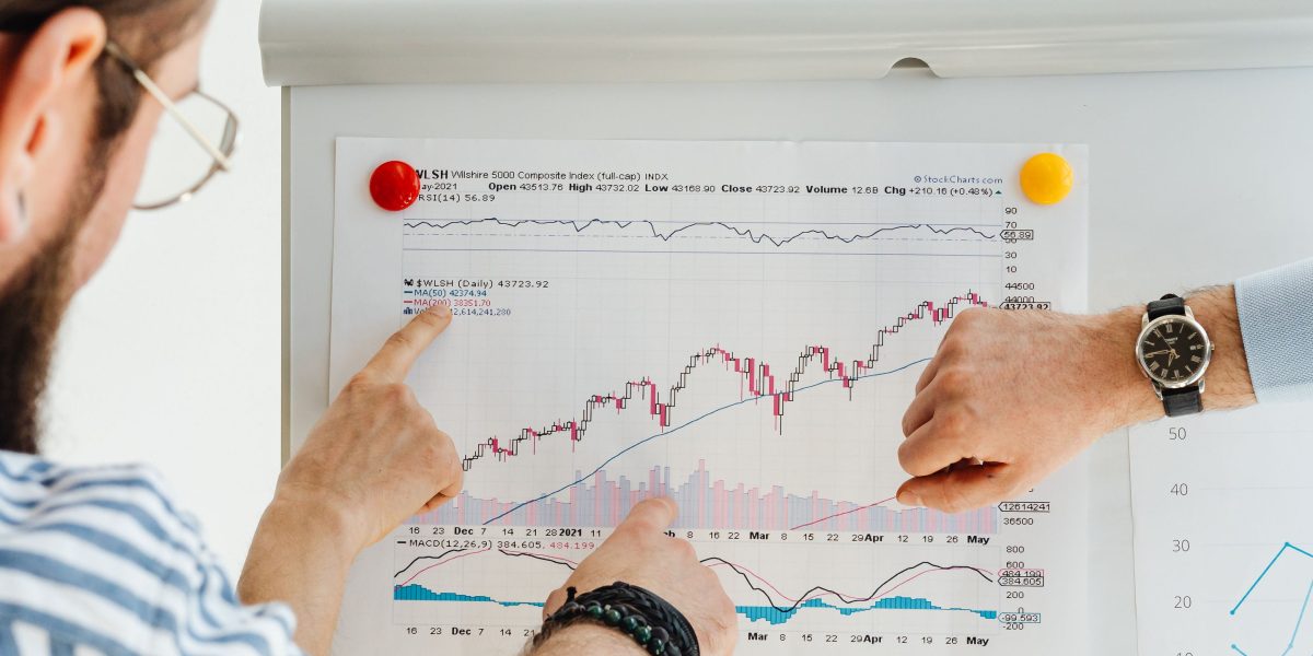 Professionals analyzing financial reports and investment portfolios, representing Infineon's strong financial health.