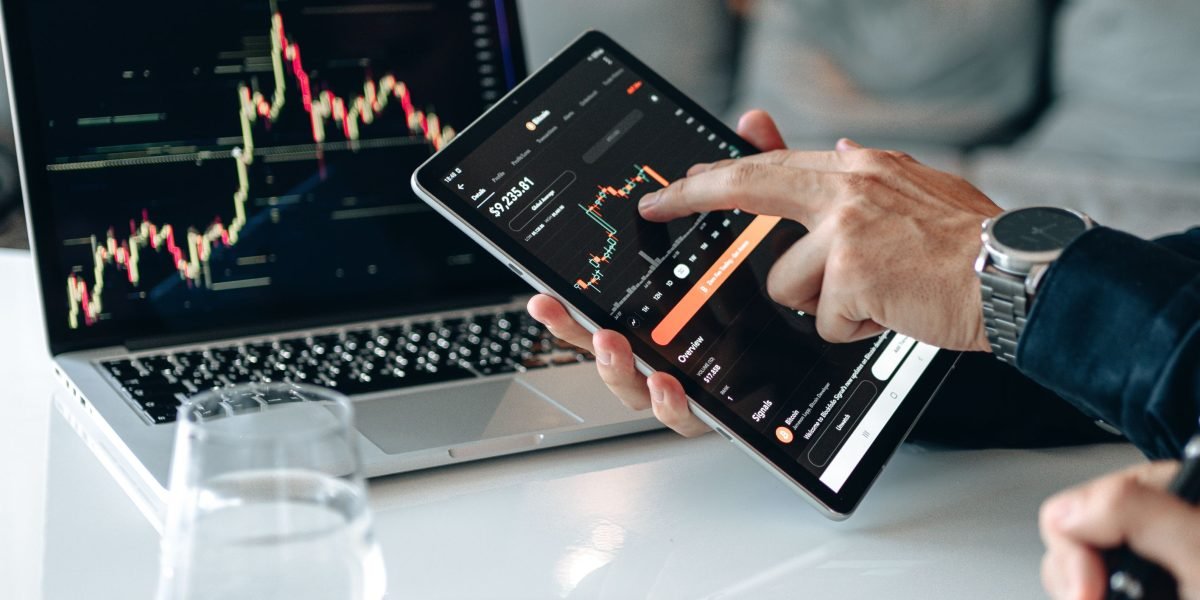 A person intently reviewing financial data to identify market patterns and trends.