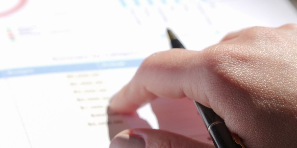 An individual carefully reviews detailed financial reports to gain a comprehensive understanding of market dynamics.