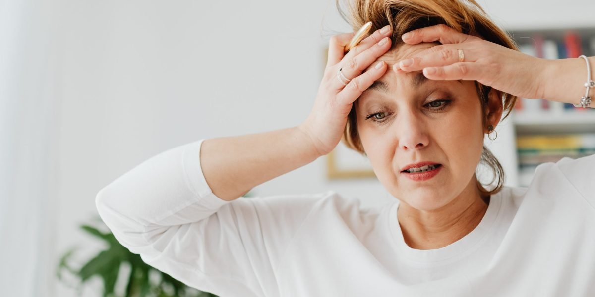 A person appears overwhelmed by a large amount of information, reflecting the challenge of sifting through Reddit discussions.