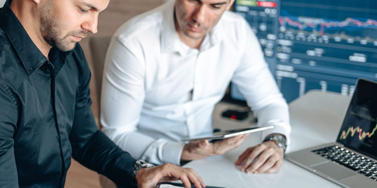 Financial professionals reviewing complex data and reports, symbolizing the calculated approach of Wall Street analysts and institutional investors.