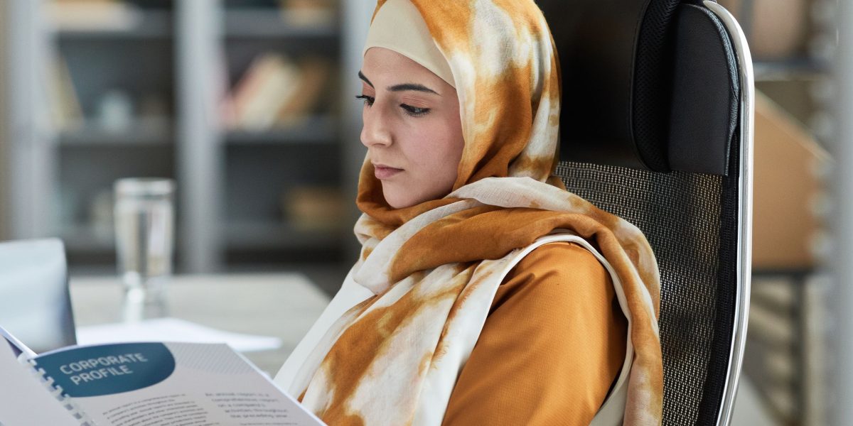 An individual intently reviewing a document, symbolizing the need to look beyond surface-level information in financial reports.
