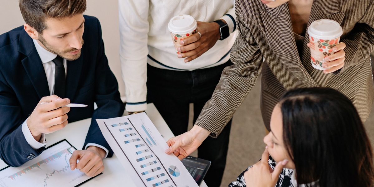 A group of professionals collaboratively analyzing financial data and reports.