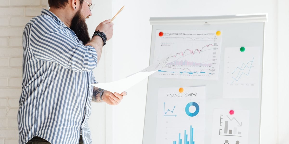 A business leader confidently pointing at a clear insight on a whiteboard, representing the skill of discerning market signals.