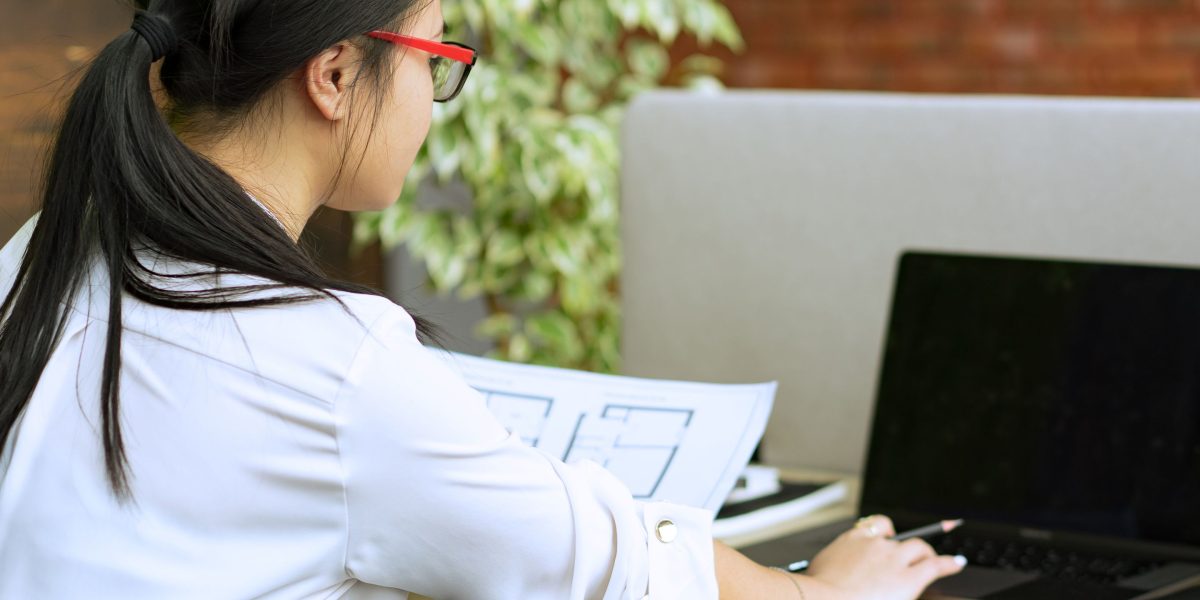 A person focused and engaged in hands-on work, possibly sketching or planning, emphasizing practical learning.