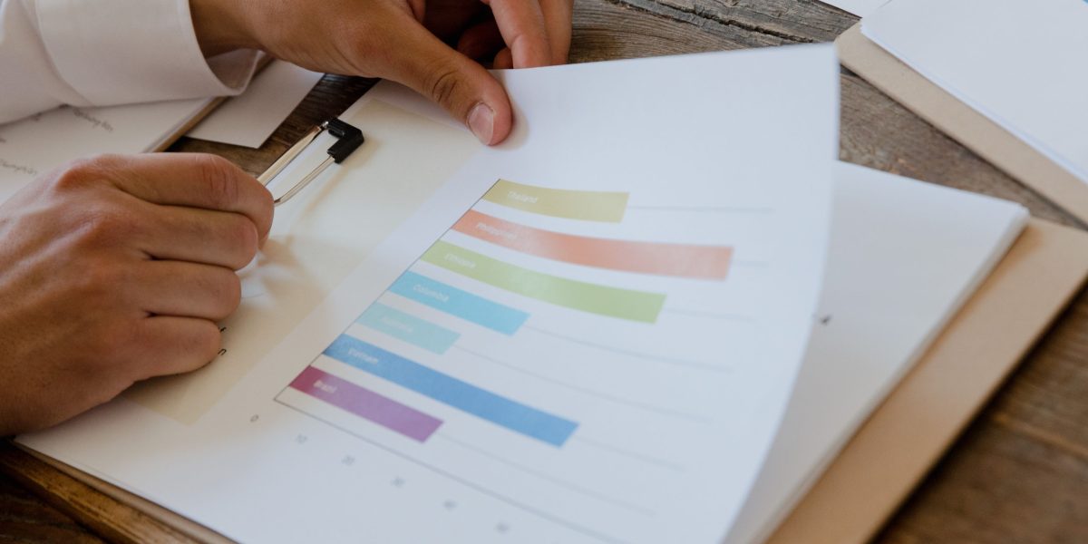 An investor thoughtfully reviews financial documents, focusing on long-term strategy rather than impulsive reactions.