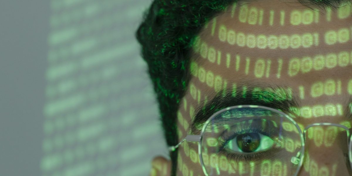 A person looking thoughtful, surrounded by many sources of information, symbolizing the challenge of making sense of AI news.