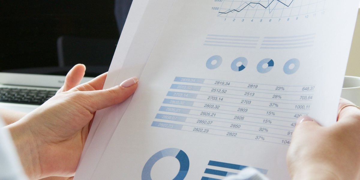 Investors meticulously analyze financial reports, seeking insights into the funding and market positioning of AI ventures.