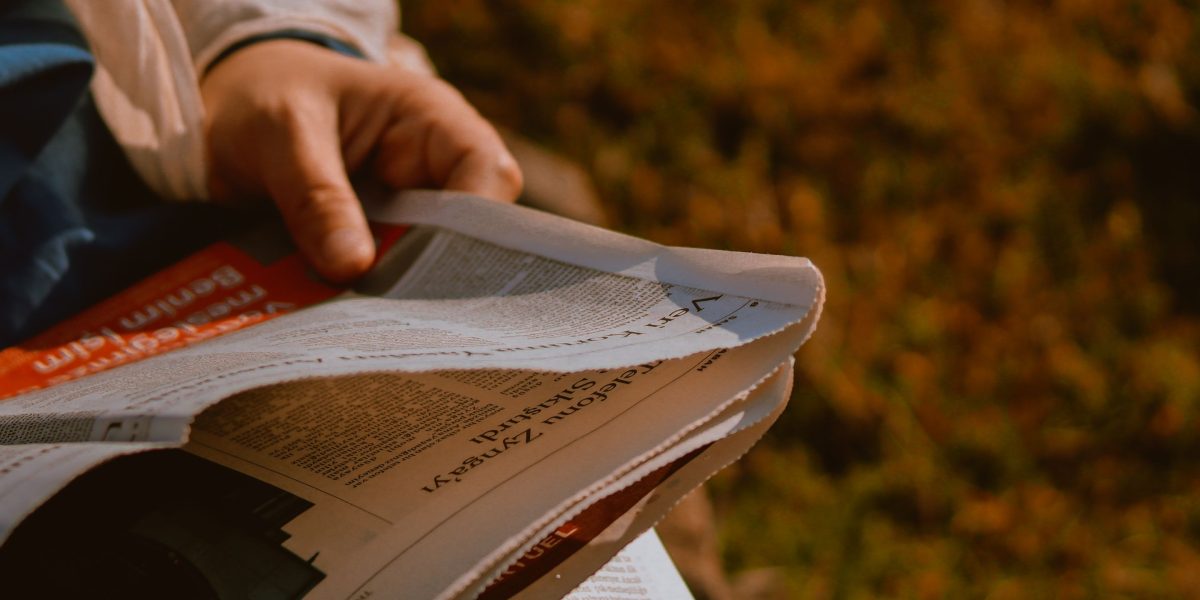 A person engages in critical reading, sifting through news to identify potential biases and ensure decisions are based on objective facts.