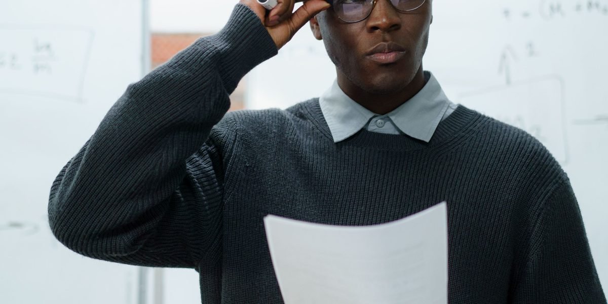 A person intently looking at multiple sources of information, symbolizing the challenge of cutting through market noise.