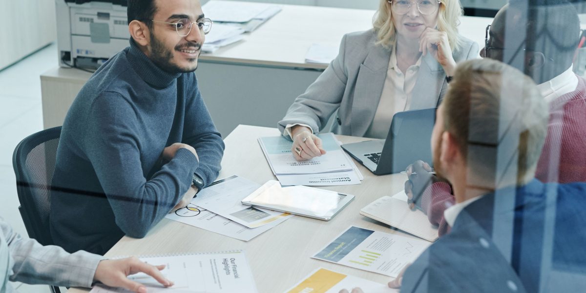 A team collaborating to analyze market dynamics and position their company against rivals, reflecting the competitive landscape.