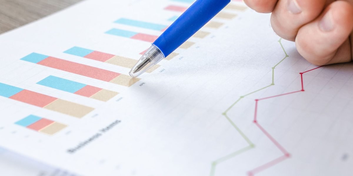 A person meticulously analyzing financial reports, discerning key insights from a large volume of information.