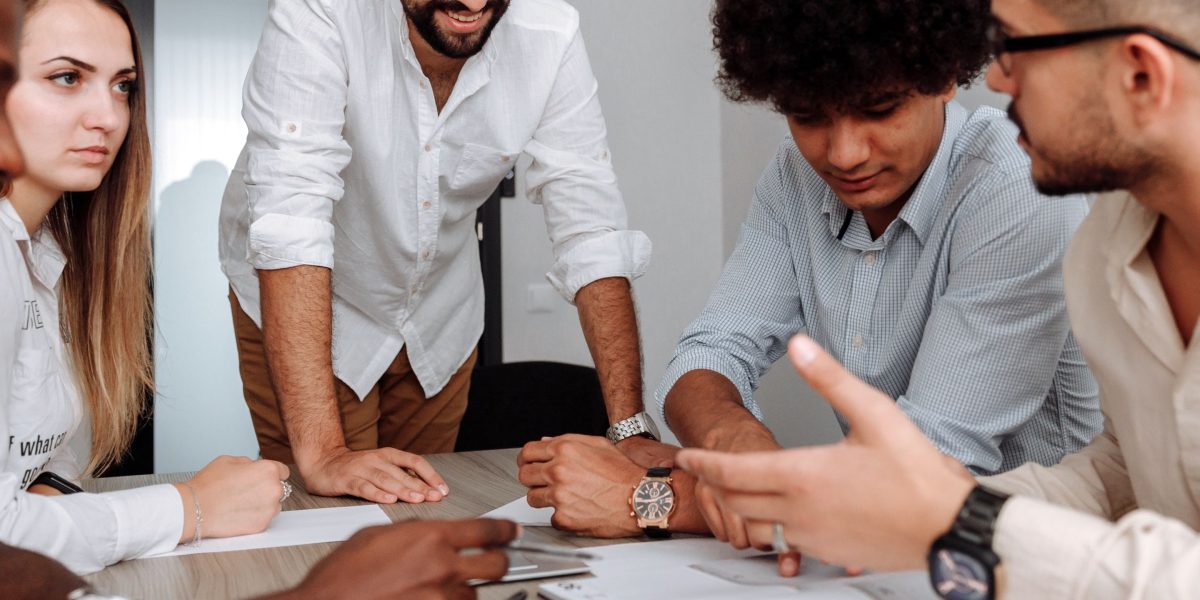 A diverse team collaborates to understand and implement complex AI solutions.